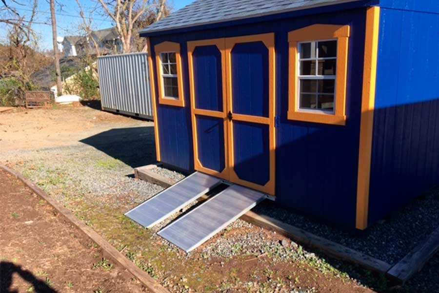 Shed Ramps attached to a blue shed hickory shed